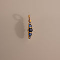 Ombre Lace Sapphire Charm pendant features five vertical blue sapphires on a neutral background with a soft shadow—ideal as a personalized charm or meaningful birth month gift.