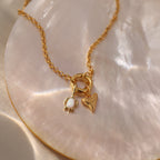 Gold chain necklace with an Opal Sea Turtle Charm on a shiny, iridescent surface—perfect for ocean-inspired, seaside jewelry lovers.