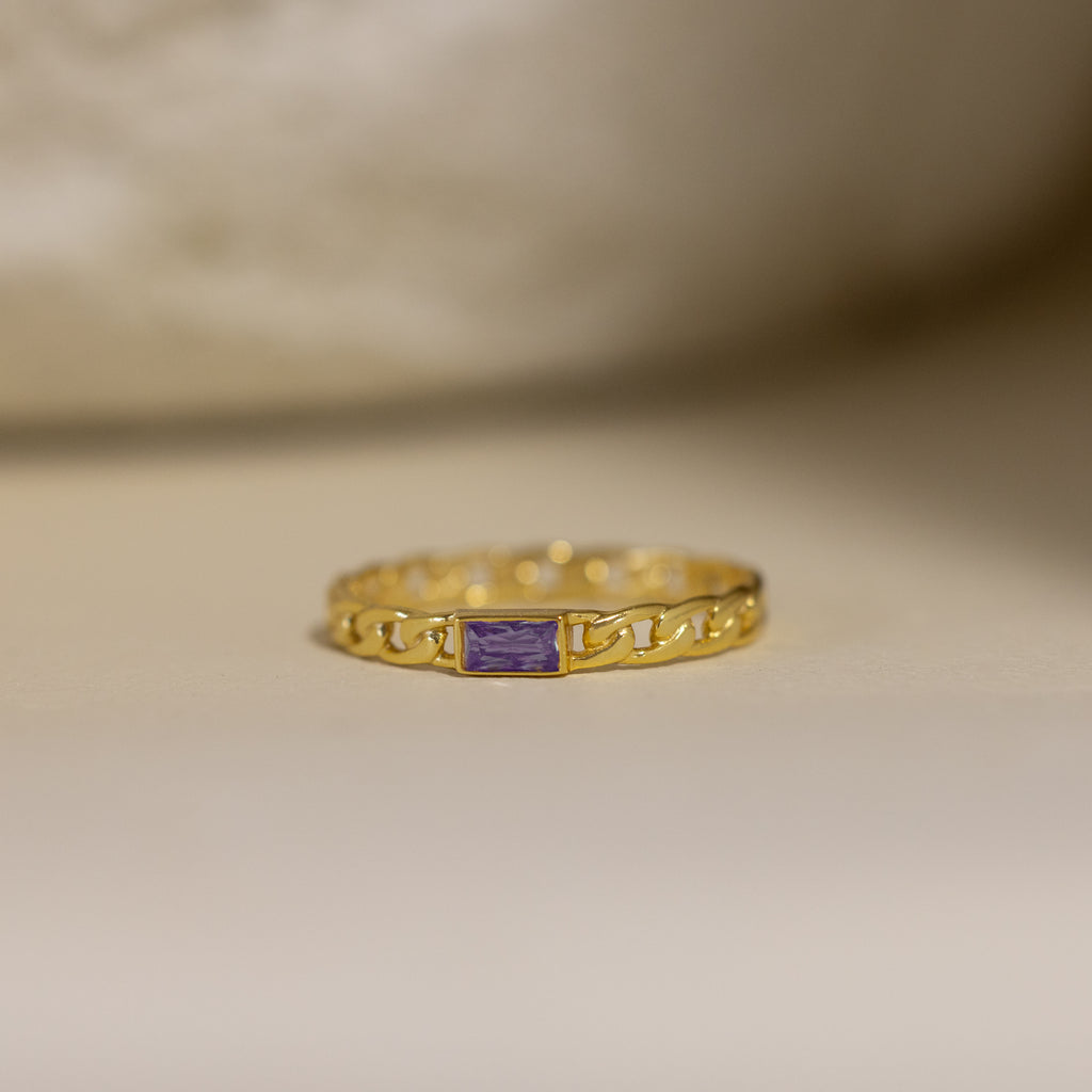 Baguette Birthstone Curb Ring in Amethyst for February, featuring a rectangular purple stone and curb-link band—an ideal piece of personalized jewelry on a neutral background.