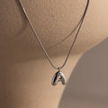 Bubble Letter Necklace in White Gold with a polished letter A pendant, displayed on a beige mannequin bust—perfect as personalized jewelry for any occasion.