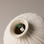 Gemstone Clover Necklace with one green malachite and one white mother of pearl four-leaf clover pendant on delicate chains.