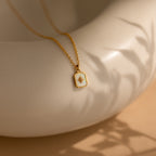 North Star Necklaces with a star design, shown on a smooth cream-colored surface with soft shadows.