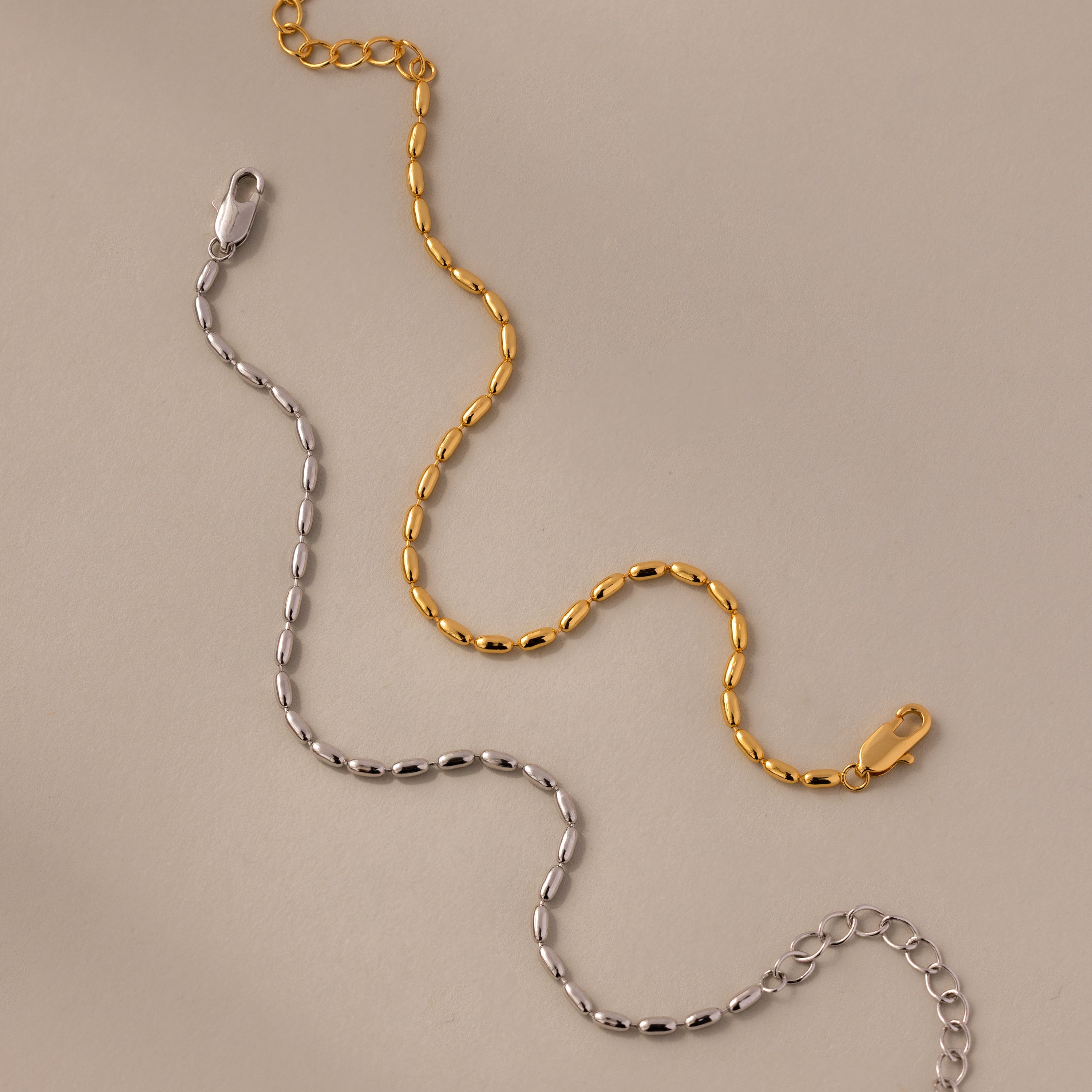 The Oval Beaded Bracelet in 18K Gold features a sleek metal chain with a lobster clasp—ideal for pairing with polished beads to add modern elegance to your jewelry collection.