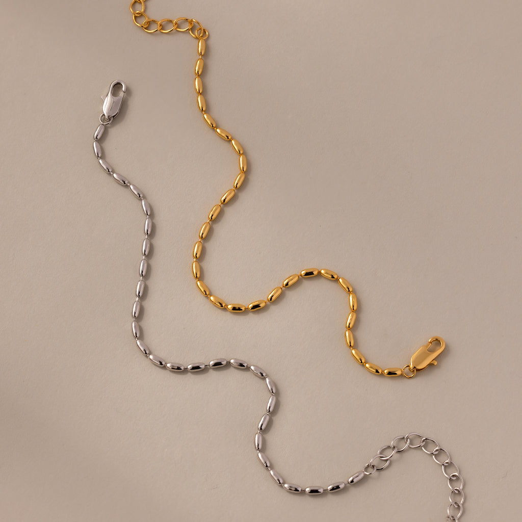 The Oval Beaded Bracelet in Silver features polished beads and a secure clasp, offering a chic touch of modern jewelry to any outfit.