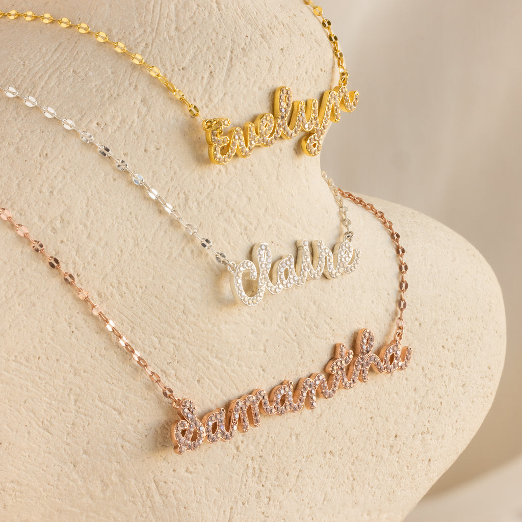 Three Pave Dream Script Name Necklaces personalized with "Evelyn" in gold, "Claire" in silver, and "Samantha" in rose gold—each custom piece adds a unique touch to your style.