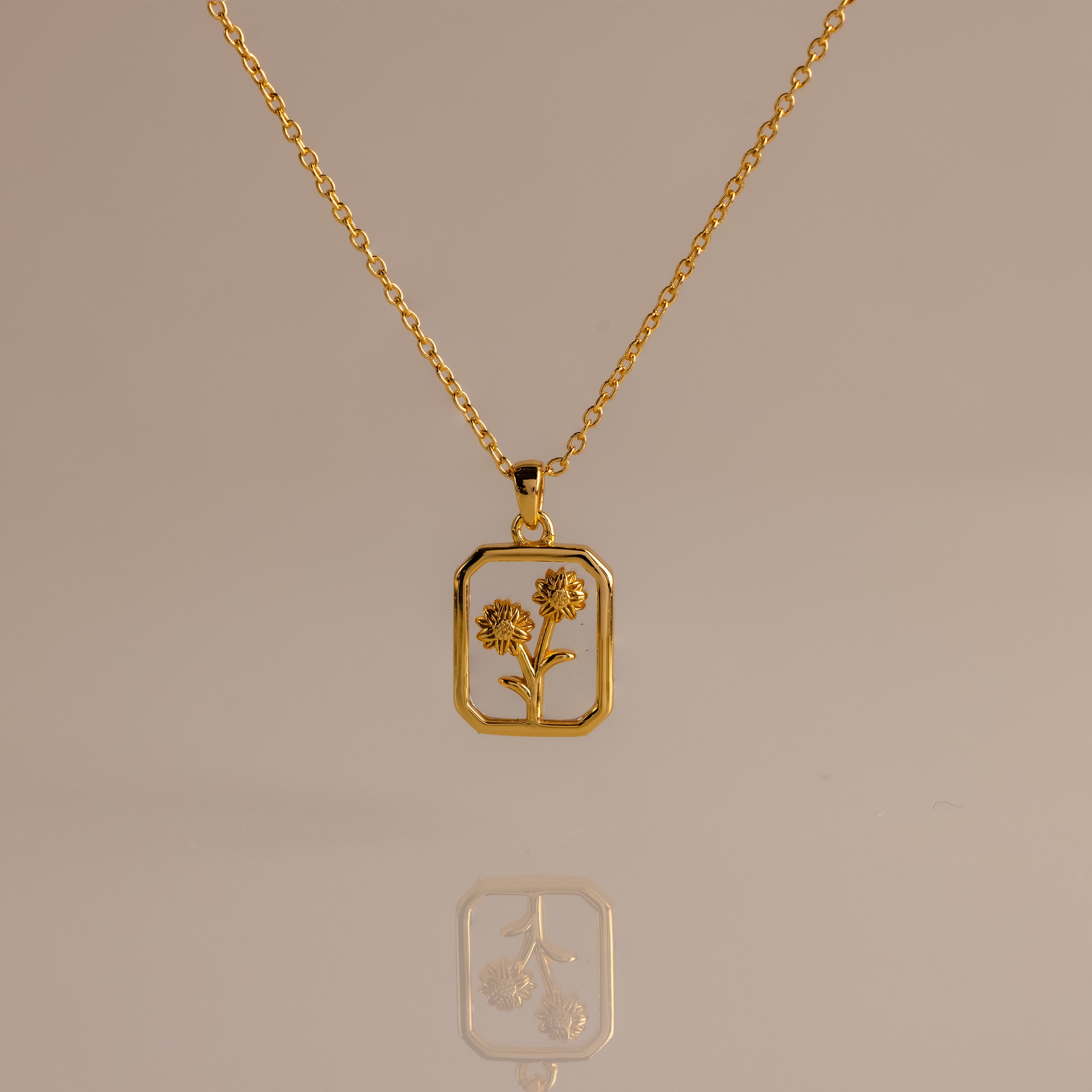Diamond Birth Flower Charm Necklace with a rectangular pendant featuring two delicate flower designs, elegantly displayed on a neutral background for a timeless, sophisticated look.