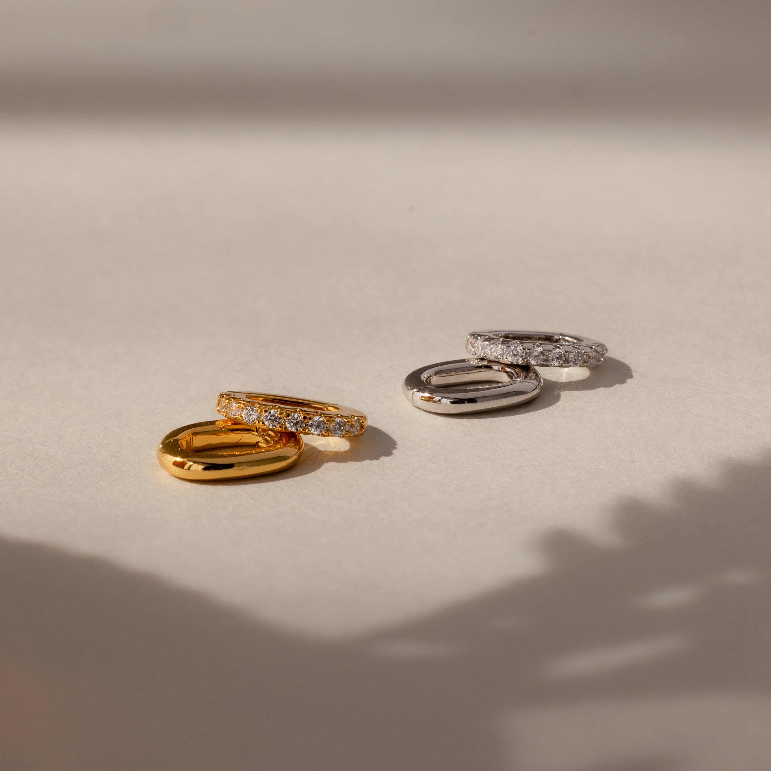 The Multipurpose Pave Ring Lock Set, in both gold and silver, is shown on a neutral background with soft shadows and features a pavé-detailed clasp for versatile jewelry customization.