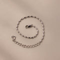 The Oval Beaded Bracelet in Silver features an elegant oval link design and a secure lobster clasp, perfect for adding a modern touch to any look.