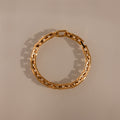 The Eternal Link Bracelet in 18K Gold showcases geometric rectangular links arranged in a circle, making it a modern essential for any jewelry collection.