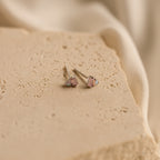 Pink Baguette Opal Studs in Silver with rectangular gemstones on a textured beige stone surface—perfect as bridesmaid or bridal gifts.