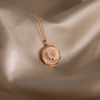 The Baby Hand & Footprint Necklace in Rose Gold features tiny engraved handprints, footprints, and the word "always"—a personalized keepsake necklace for parents to treasure.
