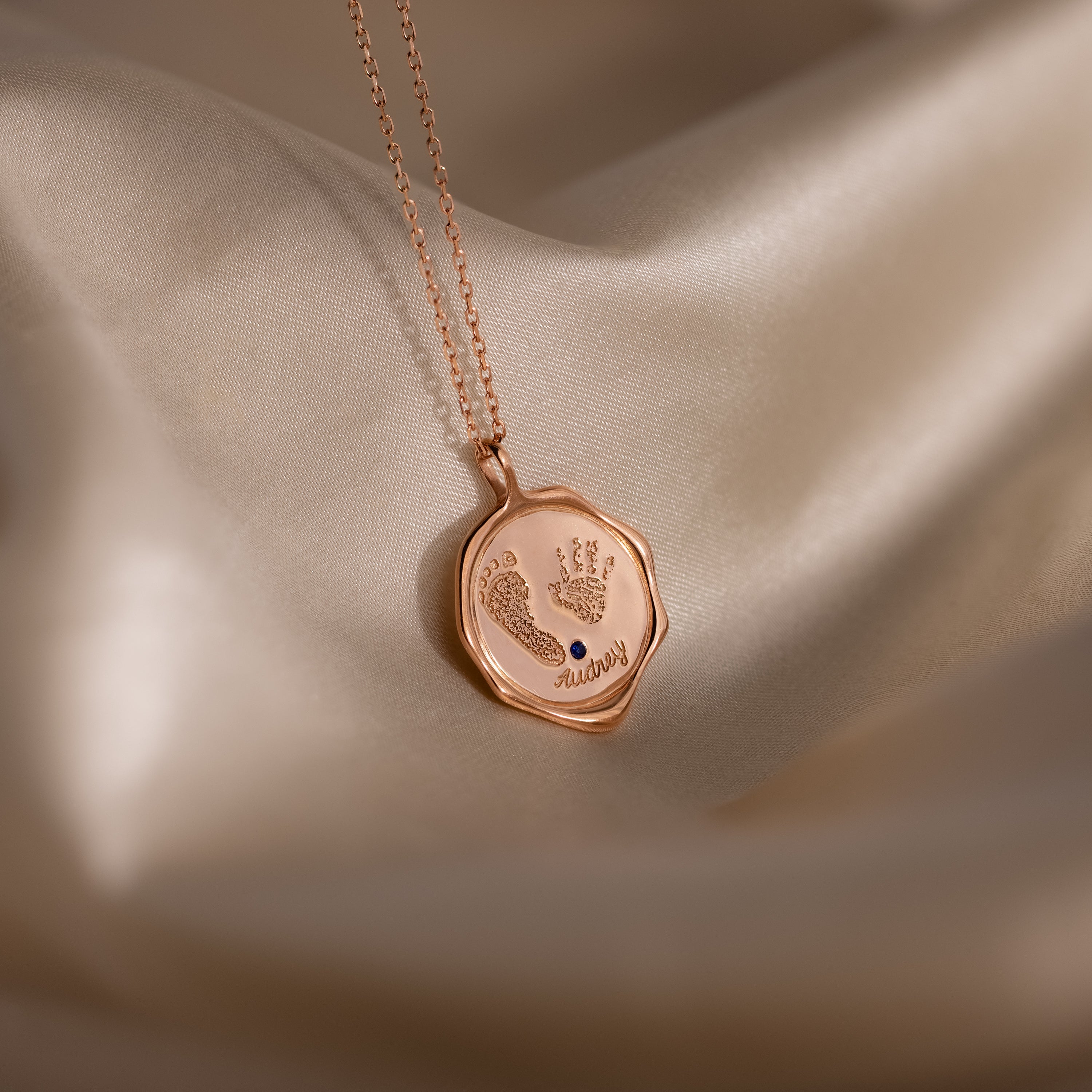 The Baby Hand & Footprint Necklace in Rose Gold features tiny engraved handprints, footprints, and the word "always"—a personalized keepsake necklace for parents to treasure.
