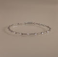 The Sprinkle Diamond Tennis Bracelet in Silver features evenly spaced round diamonds and is displayed on a neutral background.
