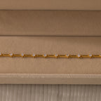 Sprinkle Diamond Tennis Bracelet in 18K Gold, featuring small round diamonds, displayed on a beige velvet jewelry box.