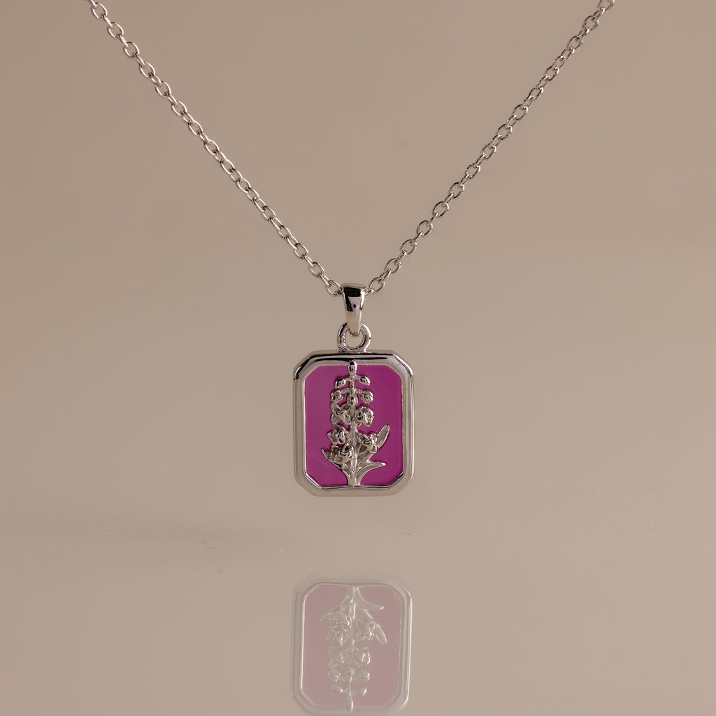 Ruby Birth Flower Charm Necklace with a rectangular pendant showcases a flower design on a pink background, mirrored below.