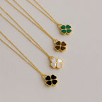 Gemstone Clover Necklace set with green malachite, brown tiger’s eye, white mother of pearl, and black onyx stones on 18K.