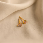 Pink Baguette Opal Studs in 18K Gold displayed on beige fabric with soft folds in the background, perfect as elegant bridal gifts.