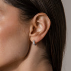 Close-up of a woman's ear wearing Beaded Chunky Hoops in Sterling Silver—modern, small silver hoops with embedded sparkling stones.