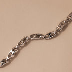 The Organic Mariner Chain Bracelet in Silver features sculptural oval links arranged diagonally, creating a timeless look perfect for any jewelry collection.