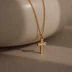 Mother of Pearl Cross Necklace in 18K Gold featuring a delicate, iridescent cross pendant on a gold chain, displayed against a neutral background for a timeless look.