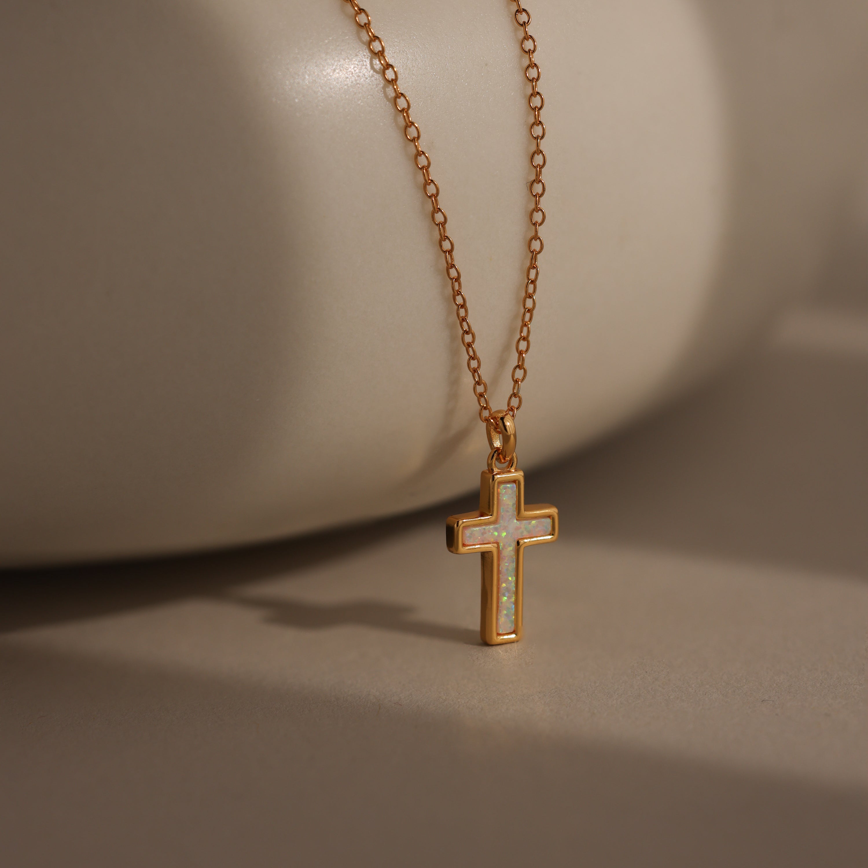 Mother of Pearl Cross Necklace in 18K Gold featuring a delicate, iridescent cross pendant on a gold chain, displayed against a neutral background for a timeless look.
