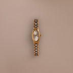 Slim Oval Timepiece in Mixed Metal, featuring a polished gold and silver link bracelet, displayed against a plain beige background.