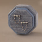 Flatlay of our Opal & Diamond Chain Studs in a Blue Velvet Jewelry Box