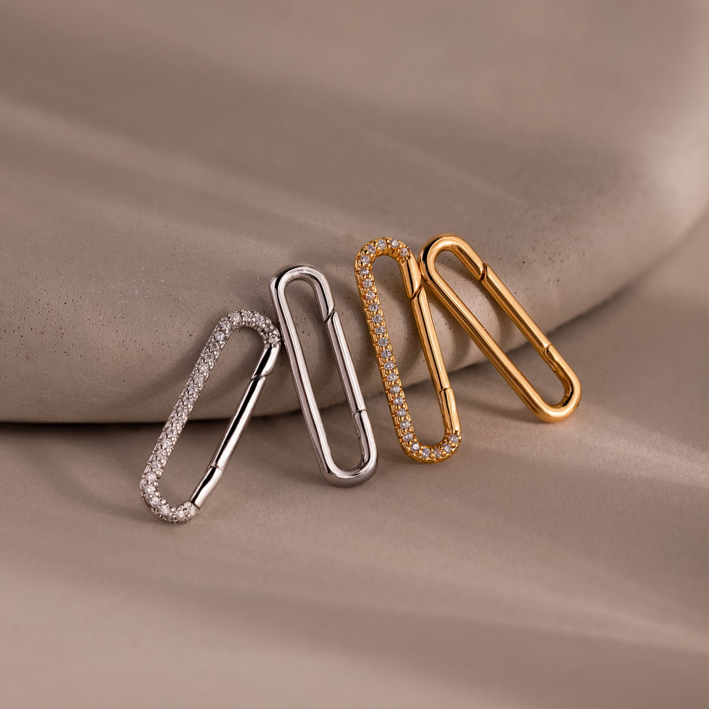 The Multipurpose Pave Link Clasp Set features three paperclip-shaped clasps in silver and 18k gold, accented with pavé diamonds, bringing effortless elegance to any jewelry look.