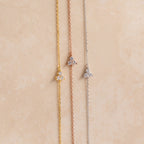The Lily Diamond Bracelet features three delicate chains in gold, rose gold, and silver, each adorned with a small three-stone diamond cluster—perfect for adding subtle sparkle to your evening attire.