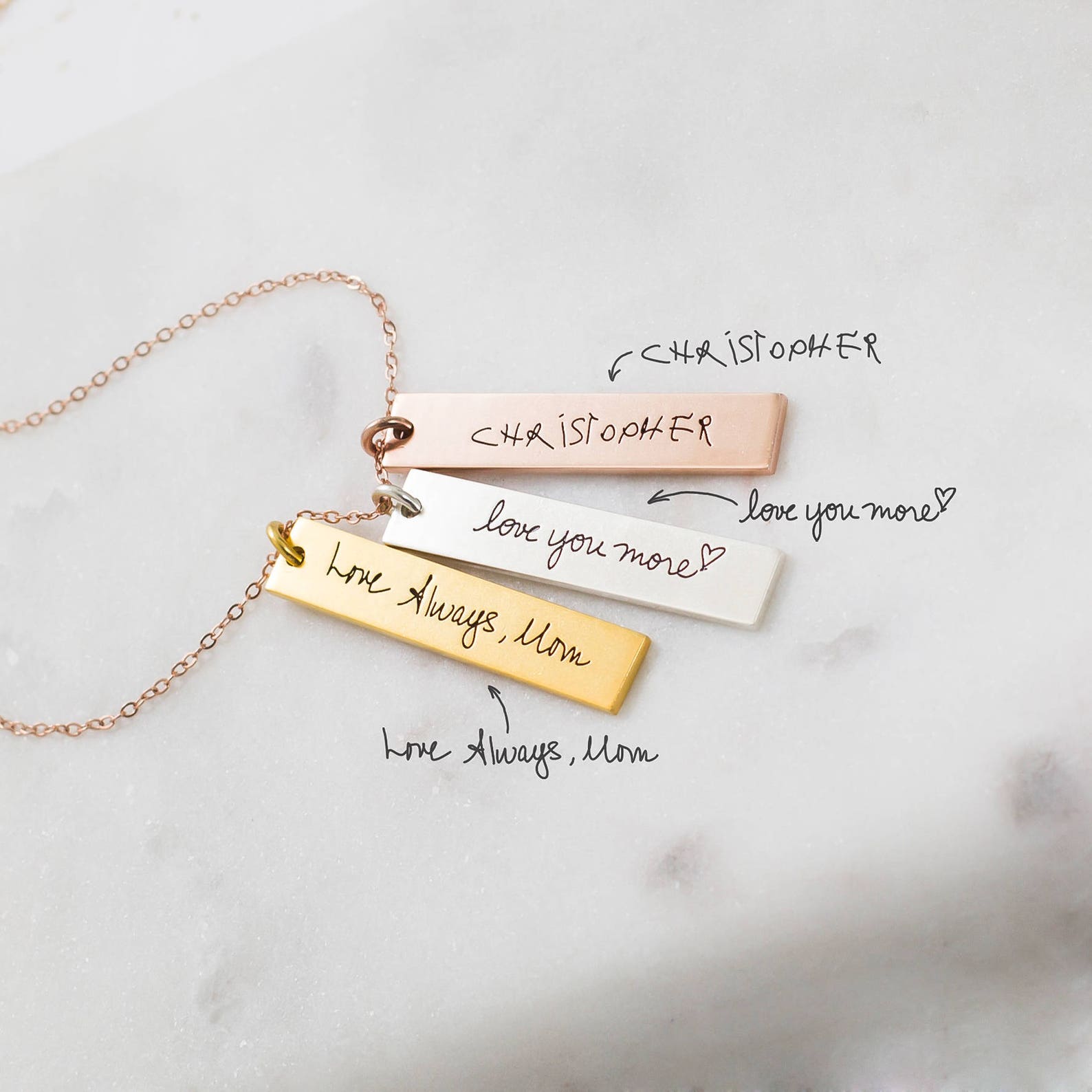 The Vertical Handwriting Bar Necklace is a personalized custom jewelry piece available in gold, silver, and rose gold, each engraved with your handwritten message.