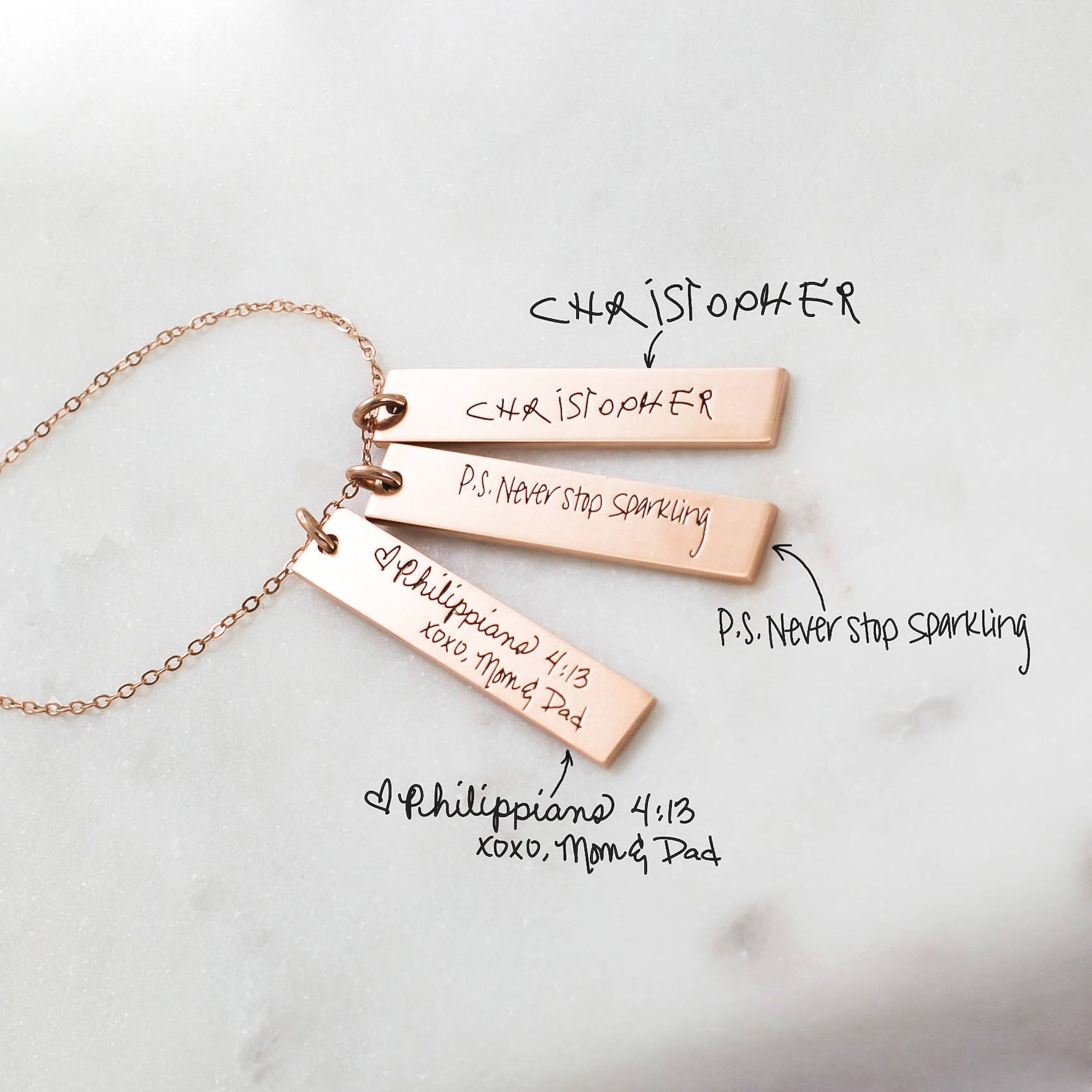 Three Vertical Handwriting Bar Necklaces engraved with personalized messages and names, highlighting custom jewelry on a white surface.