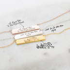 The Handwriting Bar Necklace in Rose Gold, personalized with "I love you" messages and family drawings, makes a heartfelt gift.