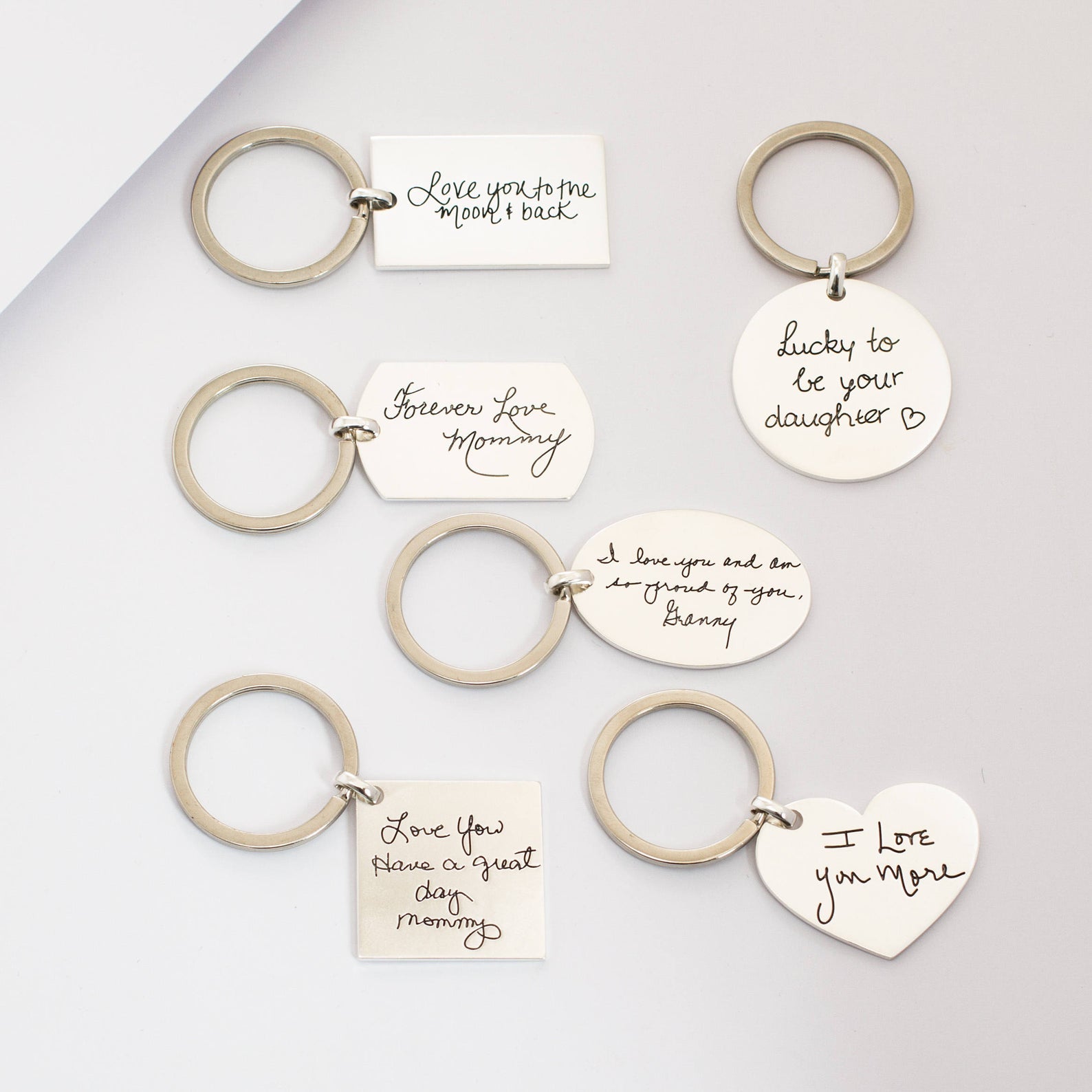 Six Handwriting Circle Keychains with handwritten sentimental messages for moms and daughters are displayed on a light surface, making each personalized keychain a meaningful keepsake.