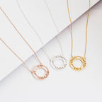 Three Roman Numerals Necklaces in rose gold, silver, and gold are displayed on a white background.
