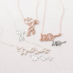 The Kids Drawing Necklace in Rose Gold features delicate animal-themed line art—balloons, a cat, and elephants—a unique piece of wearable art and the perfect personalized gift.