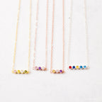 Four delicate chain necklaces, each with four colorful gemstone beads, displayed side by side—Multiple Birthstone Necklace, the perfect personalized gift for new moms or anyone wanting a meaningful custom birthstone necklace.