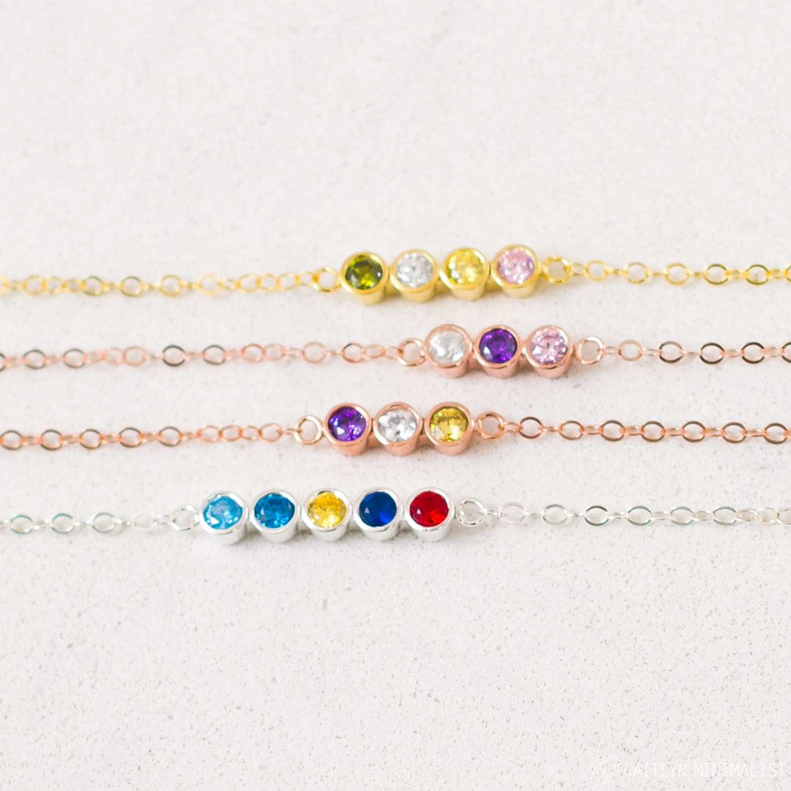 The Multiple Birthstone Necklace features five colorful gemstones in a delicate row, making it a thoughtful gift for new moms or anyone who loves the charm of personalized jewelry.