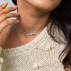 A woman wearing a Multiple Birthstone Necklace adds a special touch to her style, making it the perfect gift for new moms.
