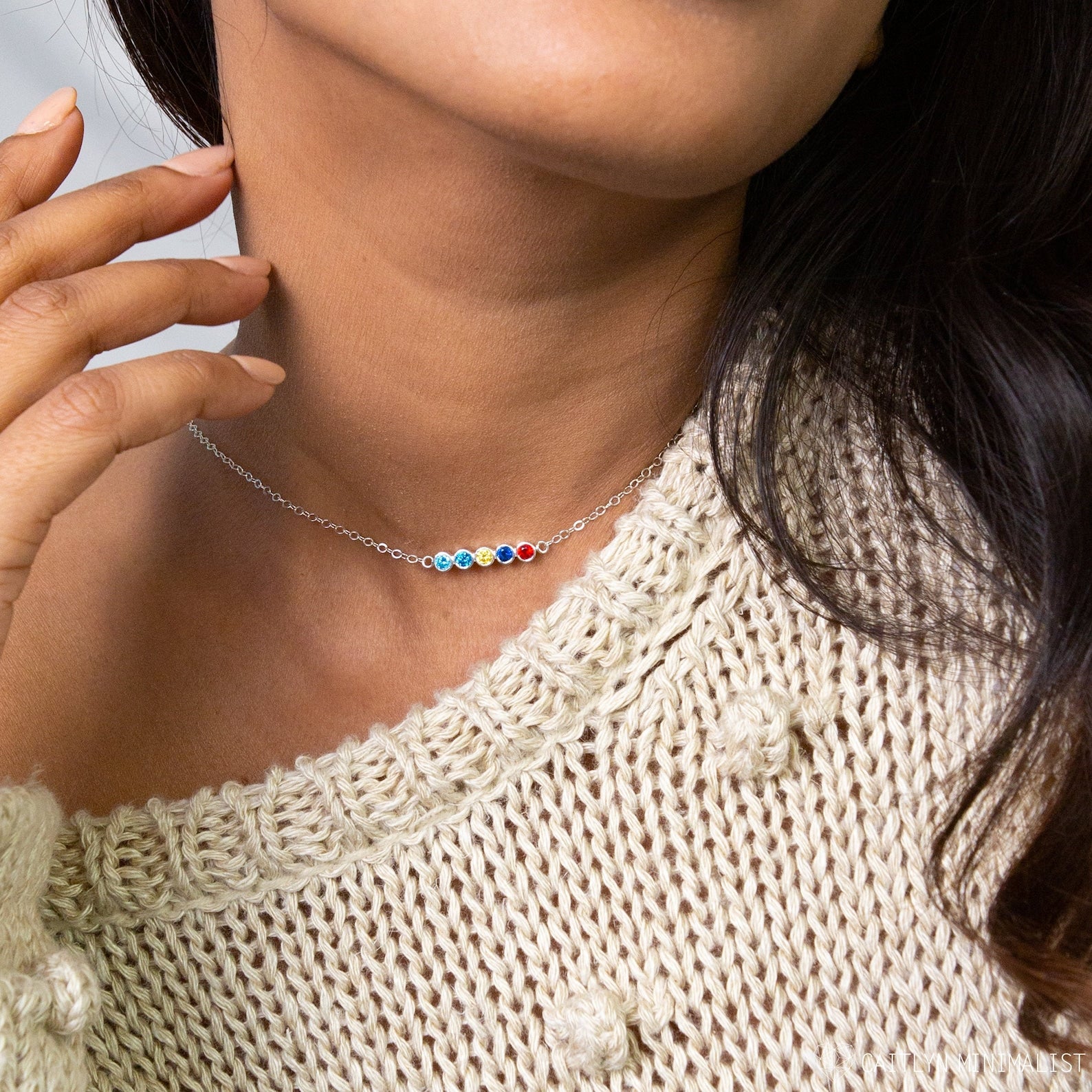 Close-up of a woman wearing a Multiple Birthstone Necklace with colorful beads and a cream knitted sweater—an ideal personalized gift for new moms.