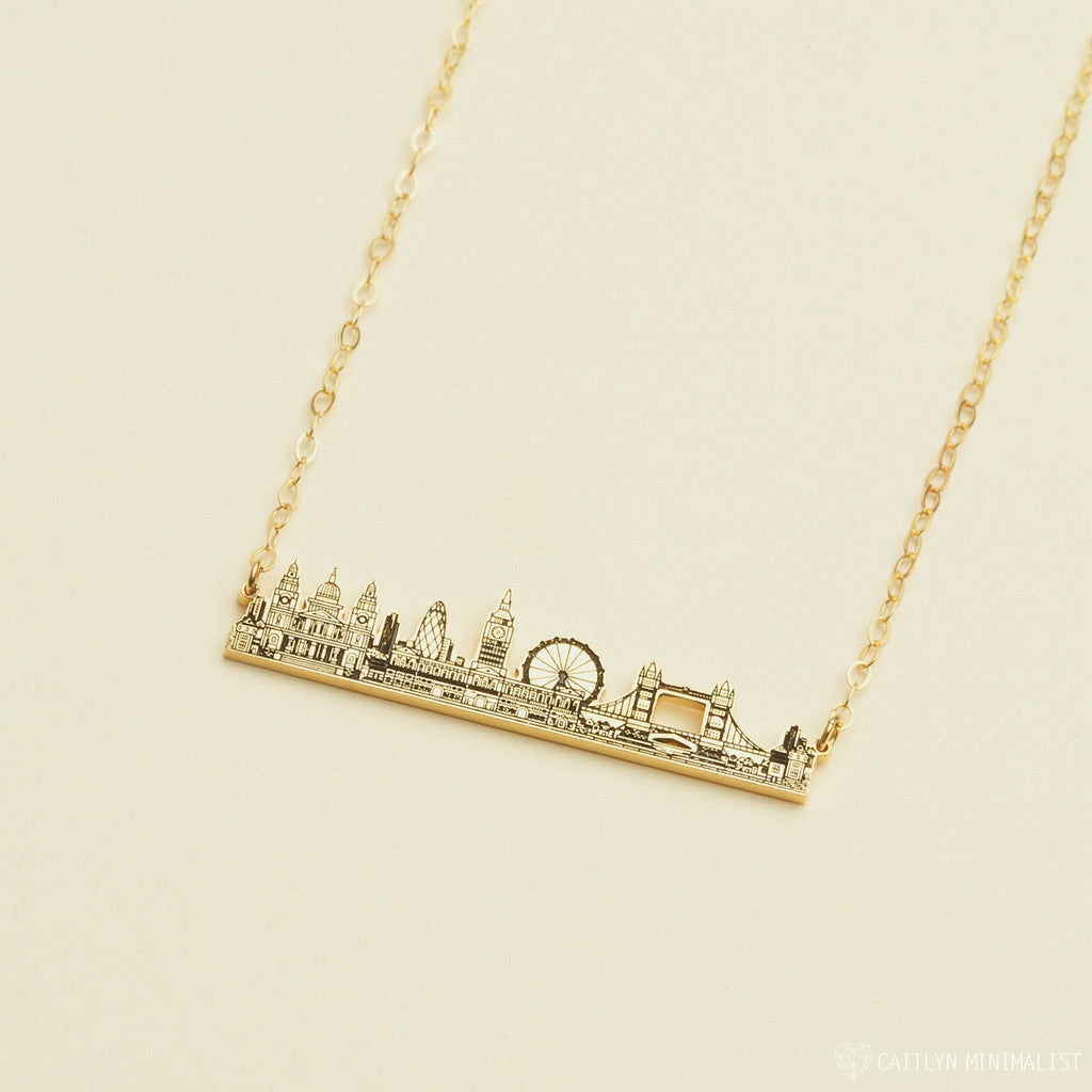 The City Skyline Necklace features a gold bar pendant with a detailed city skyline silhouette on a delicate chain—an ideal personalized gift for someone special.
