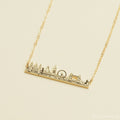 The City Skyline Necklace features a gold bar pendant with a detailed city skyline silhouette on a delicate chain—an ideal personalized gift for someone special.