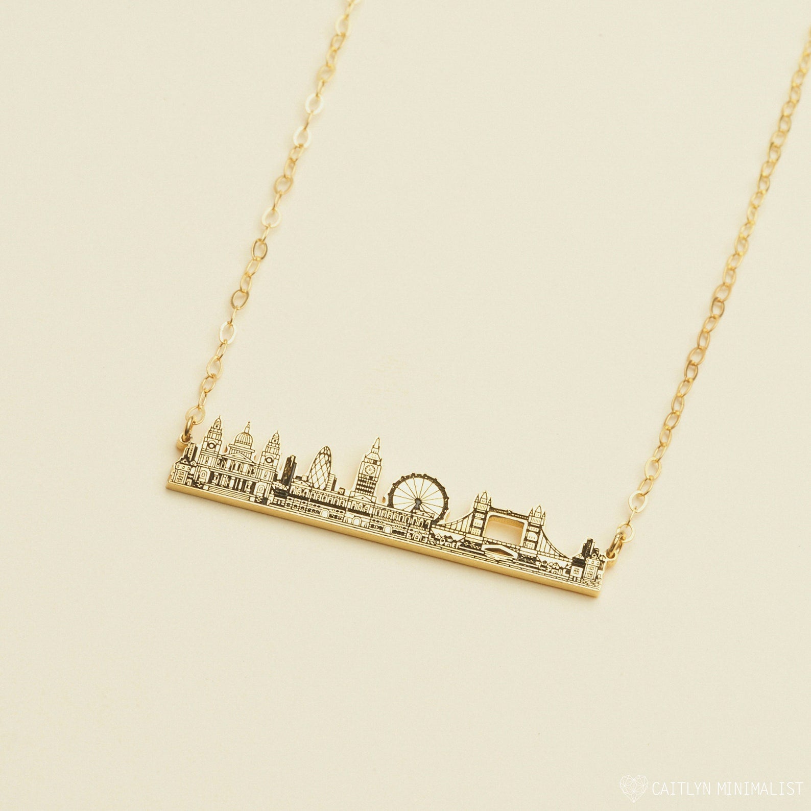 The City Skyline Necklace features a gold bar pendant with a detailed city skyline silhouette on a delicate chain—an ideal personalized gift for someone special.