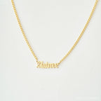 Old English Name Necklace in Curb Chain features the name Aubree in a stylish old English font on a white background, with a personalized charm and elegant curb chain for added style.