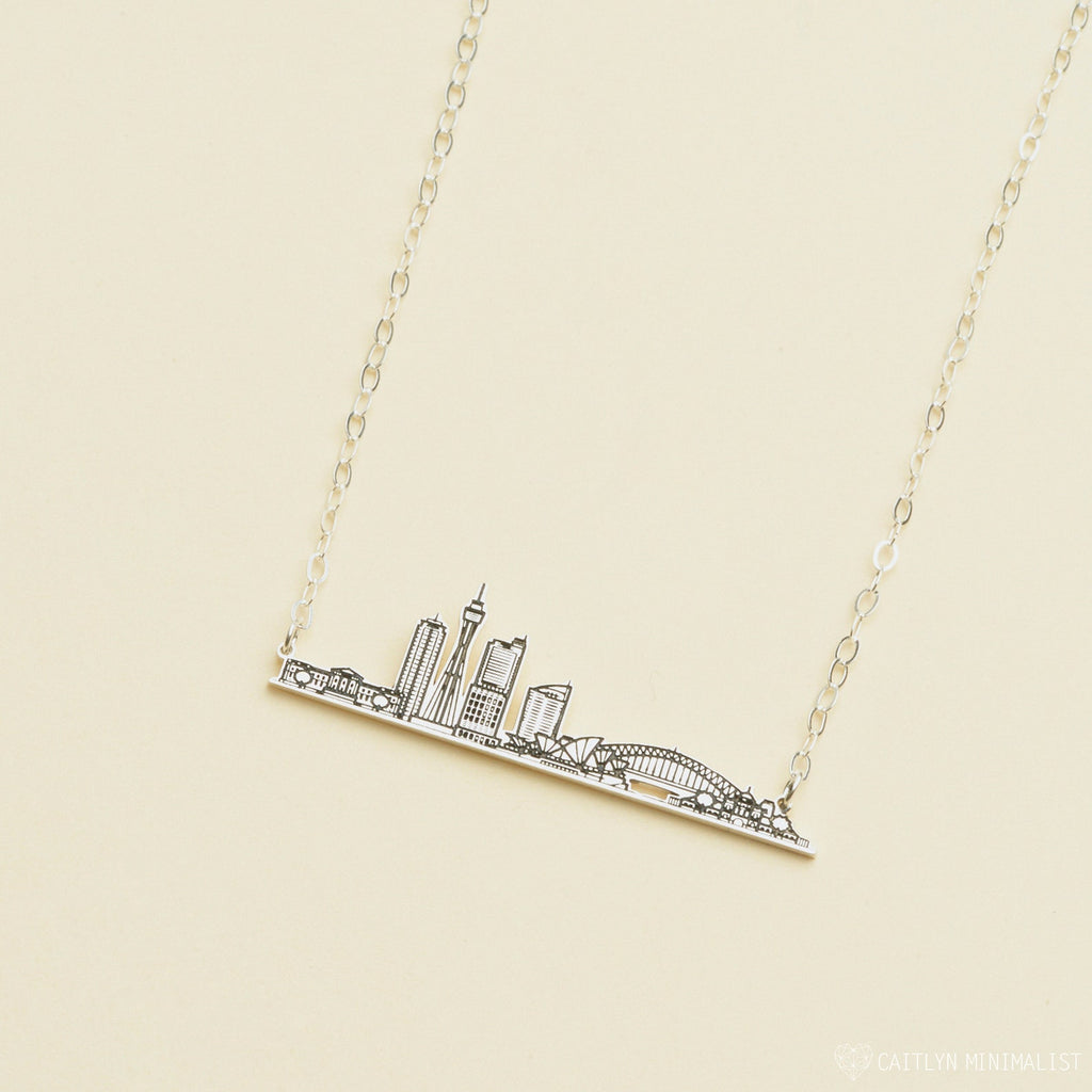 City Skyline Necklace featuring a pendant with iconic buildings and a bridge—a unique cityscape accessory that makes a perfect personalized gift.