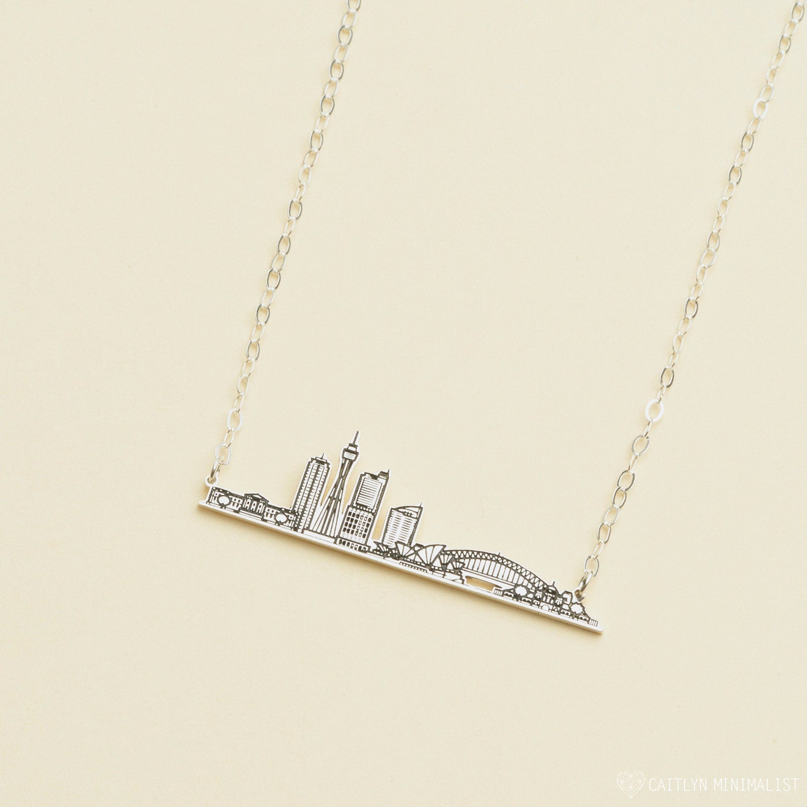 City Skyline Necklace featuring a pendant with iconic buildings and a bridge—a unique cityscape accessory that makes a perfect personalized gift.