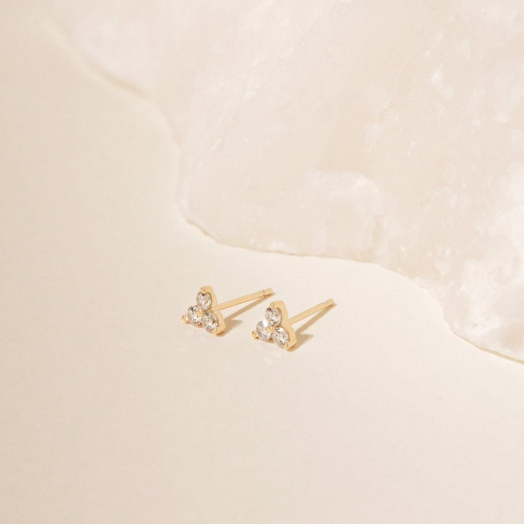 Lily Studs featuring three small gemstones each, ideal for an elegant earring stack, showcased on a soft beige background.
