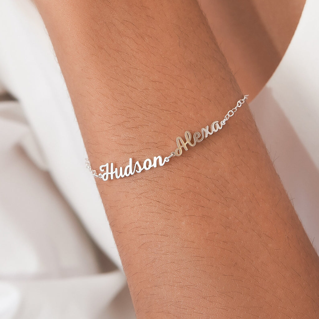 The Classic Multiple Name Bracelet showcases dainty chains with names like Hudson and Alexa in elegant cursive—a perfect piece of personalized jewelry for any occasion.