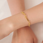 The Classic Multiple Name Bracelet features a dainty chain with names in elegant script, shown on a wrist against a neutral background—a lovely piece of personalized jewelry.