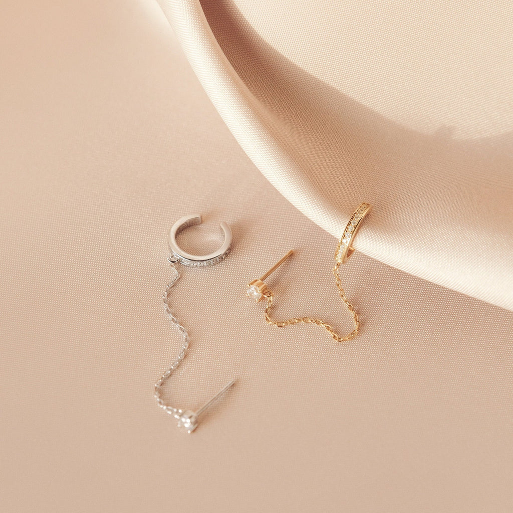 Pave Chain Ear Cuffs shown on soft beige satin fabric.
