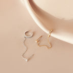 Pave Chain Ear Cuffs shown on soft beige satin fabric.